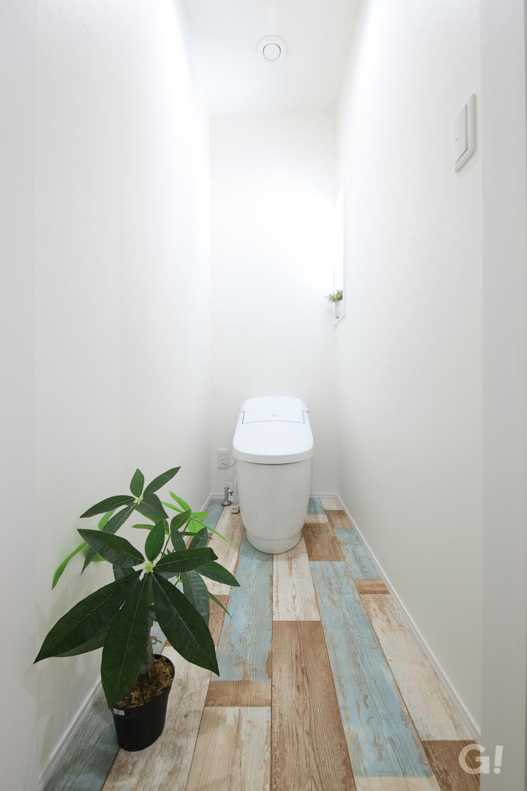 ビンテージ調のフロアを使用した爽やかな雰囲気のトイレ