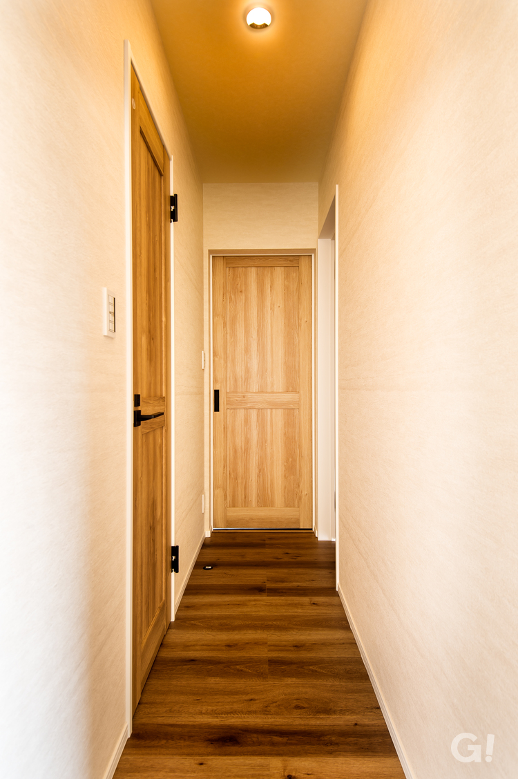 色違いの天然木を組み合わせたドアがお洒落な廊下の写真