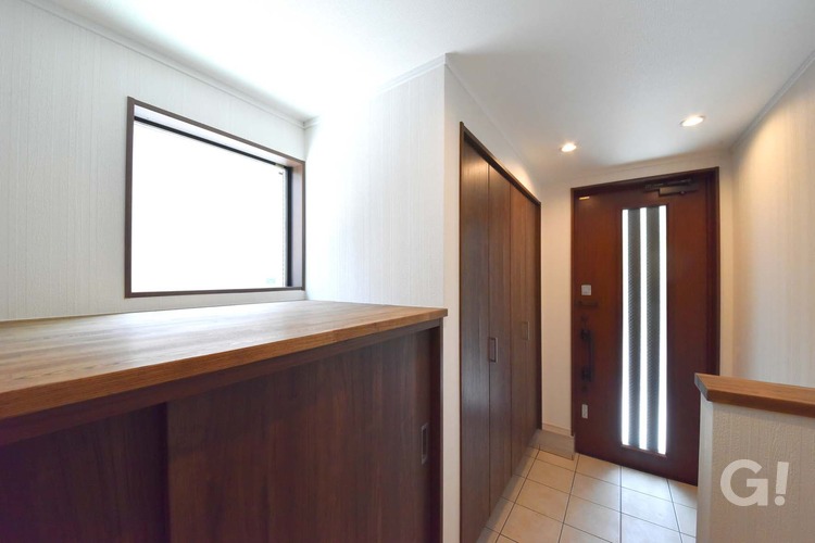 『シンプルモダンな空間！大容量収納を兼ね備えたナチュラルな家の玄関』の写真