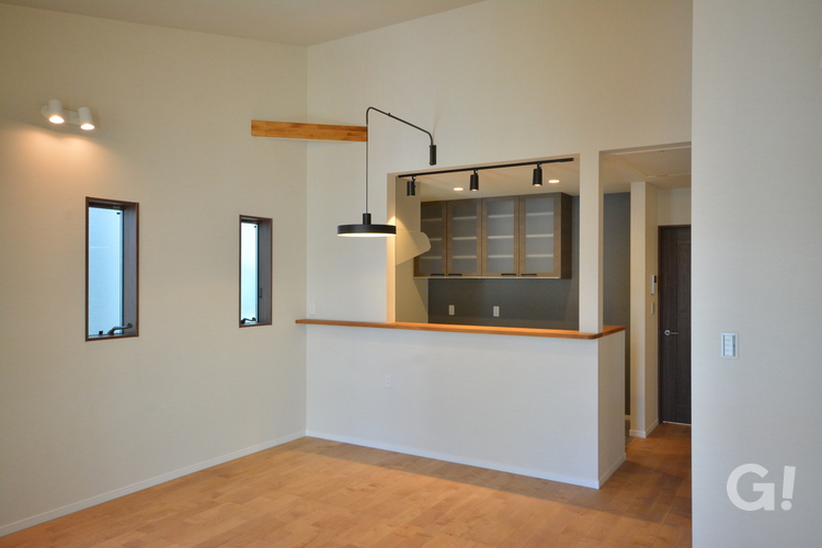 『ネイビーグレーのクロスが落ち着きある空間にしてくれるナチュラルな家のキッチン』の写真