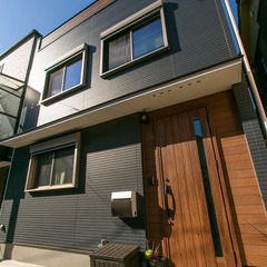 直線に繋がるデザインが美しく木材の玄関ドアで優しさ感じるナチュラルな家